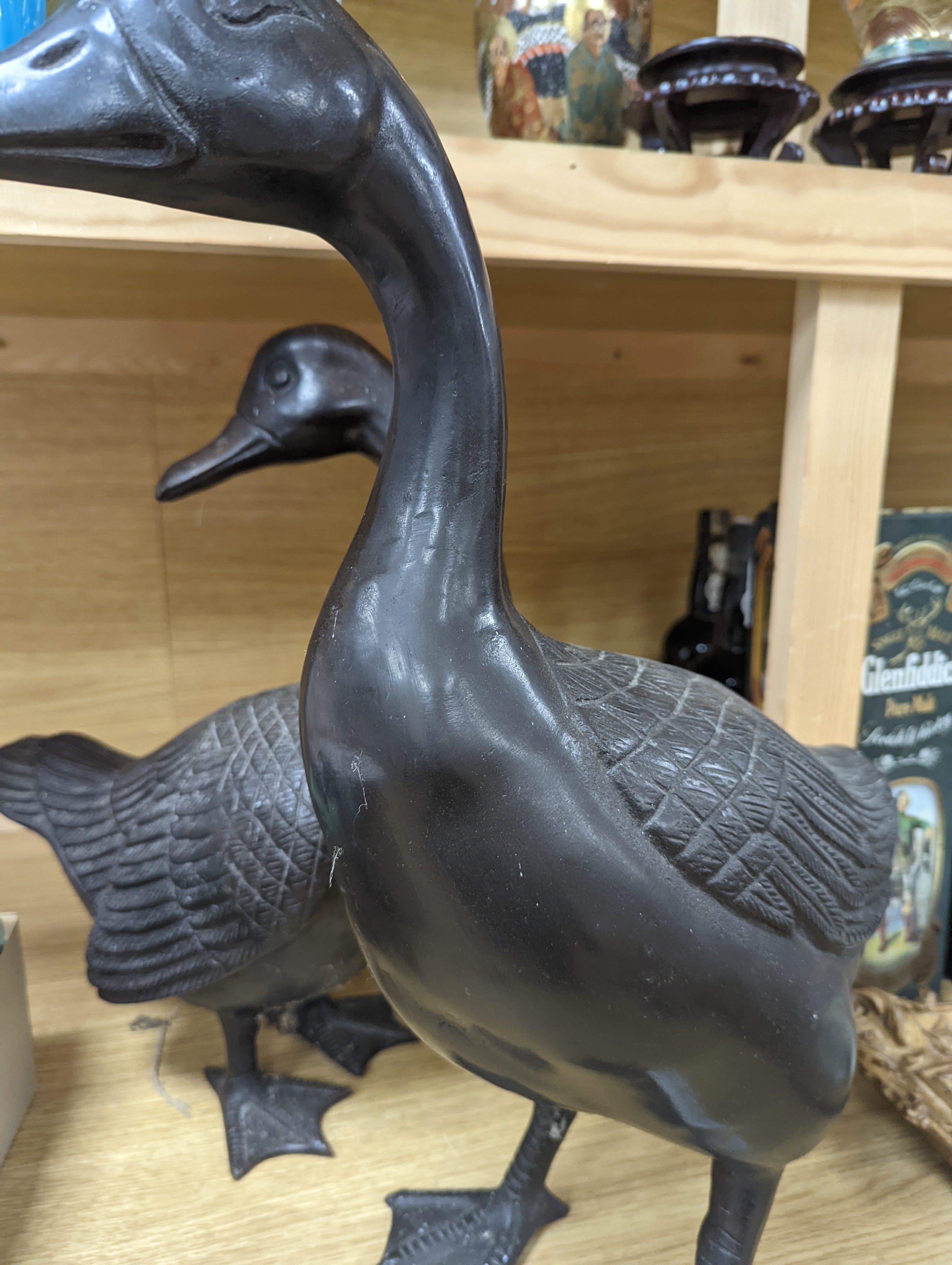 A pair of modern Chinese bronze models of geese, largest 48cm